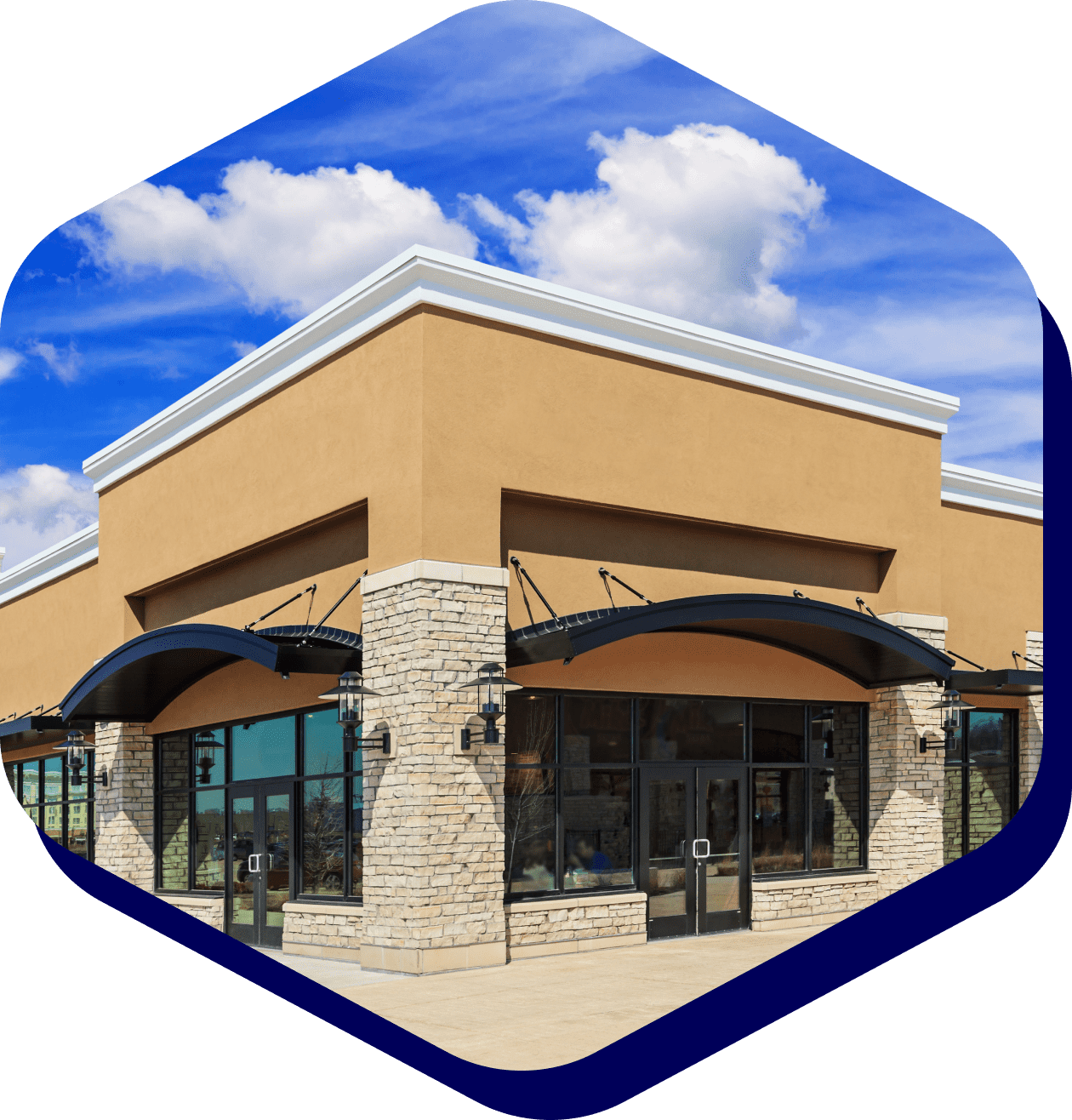 Modern storefront with stone facade and awnings.